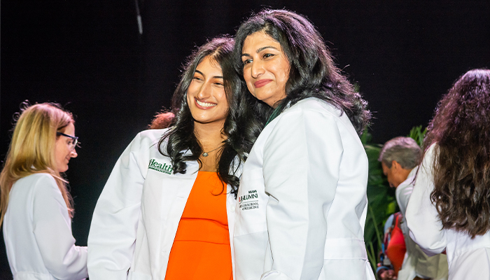 2 med school graduates posing for a picture