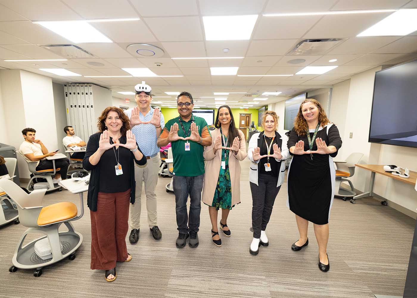 group of researchers pose for a photo in their vr lab