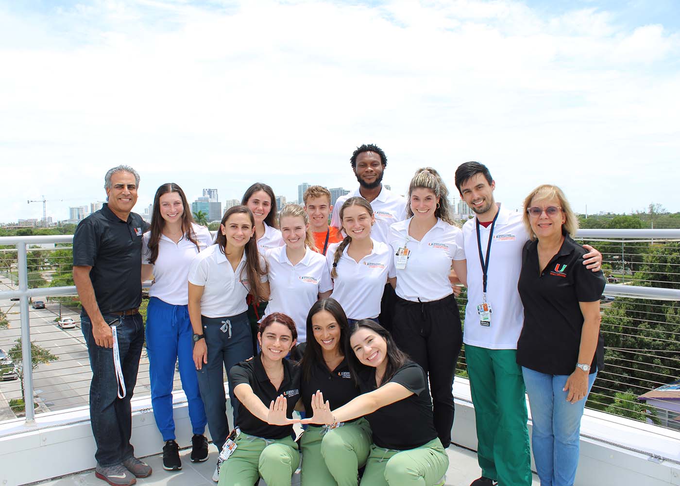 Group photo on top of a building with miami in the background