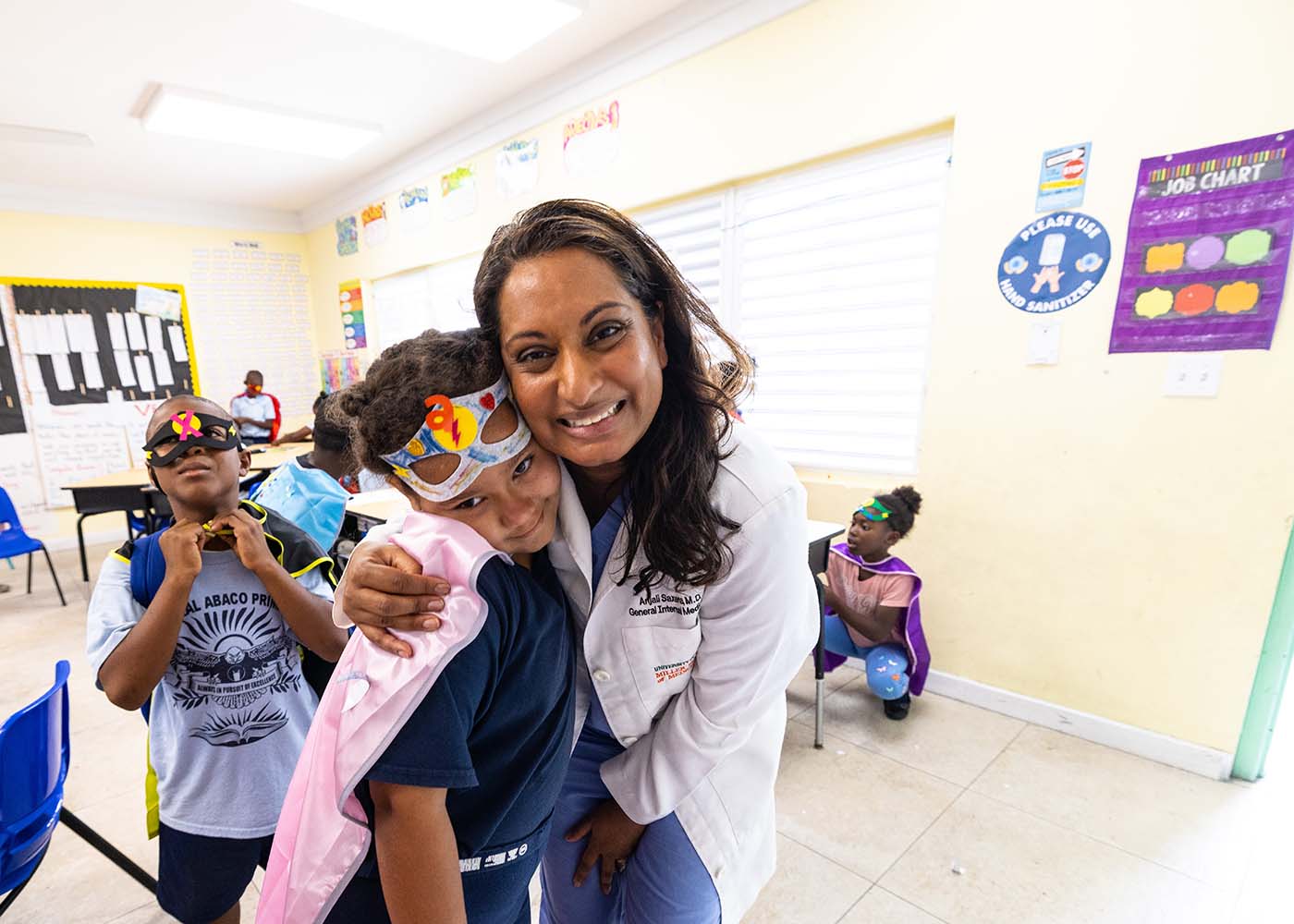Pediatrician and patient pose for a photo-1400x1000
