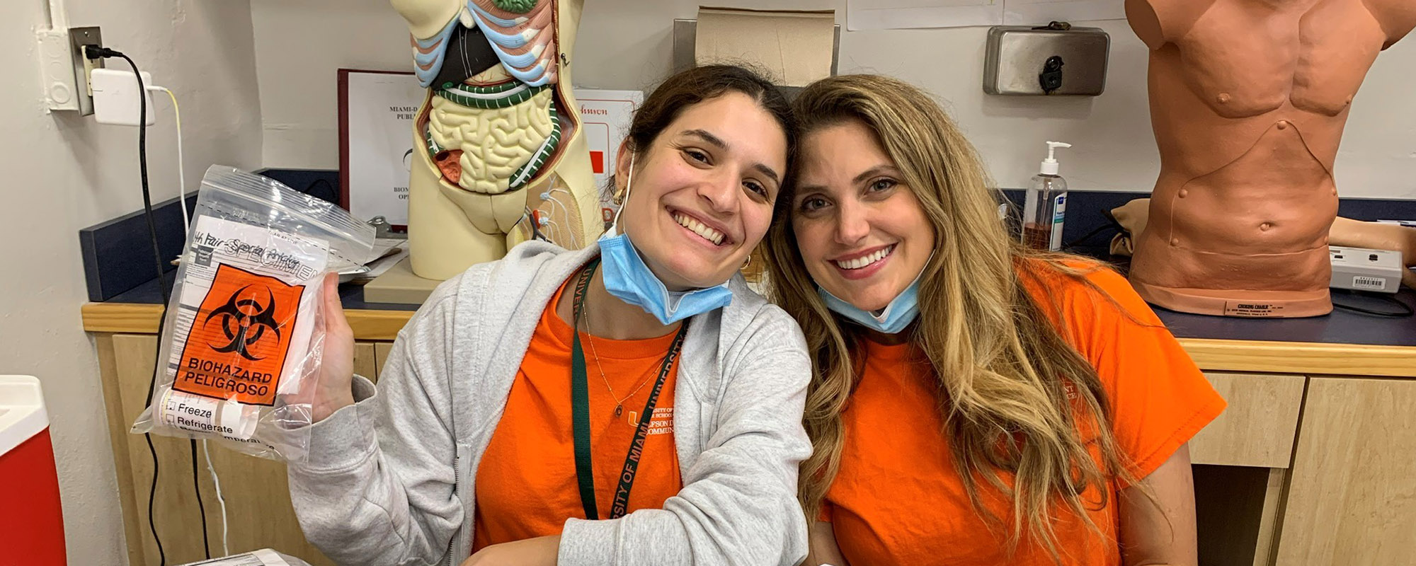 two DOCS smiling with a sample