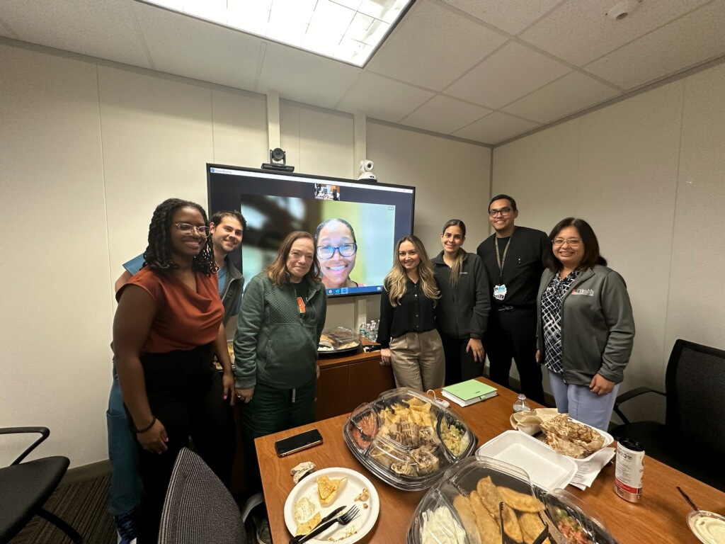 Seven Tozman Scholars attending a small event