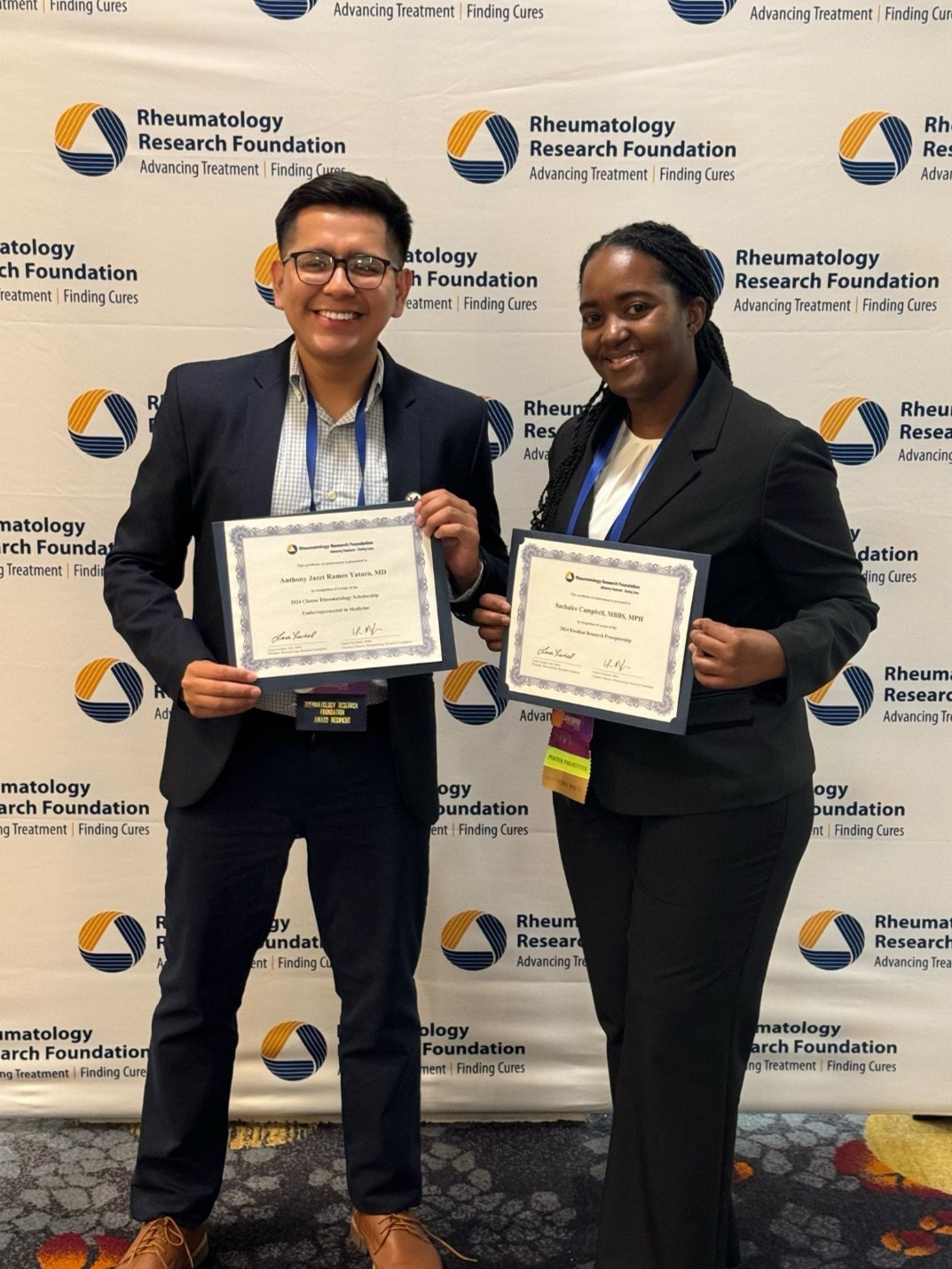 Two rheumatology fellows accepting awards