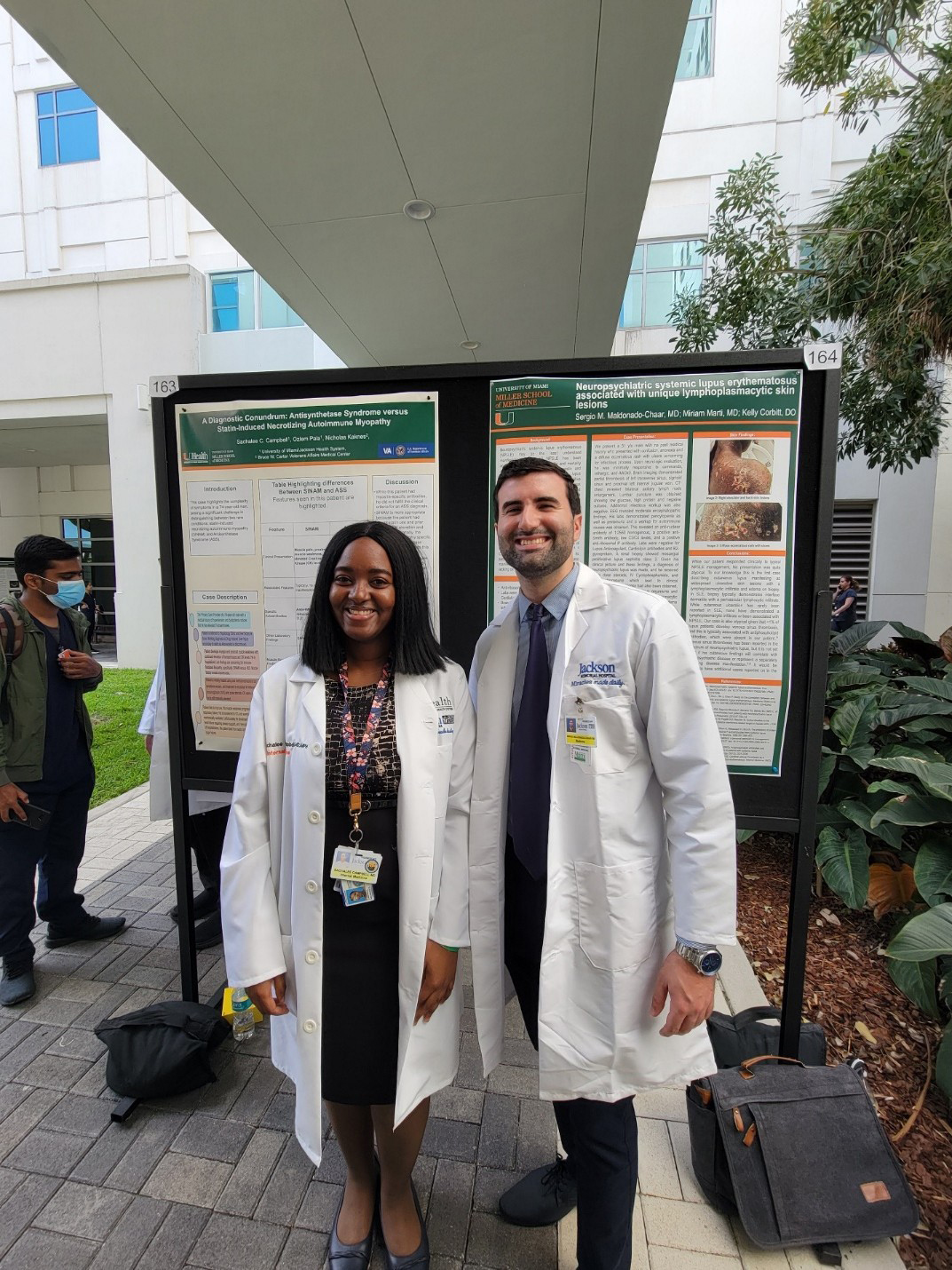 Two rheumatology fellows outside in white coats