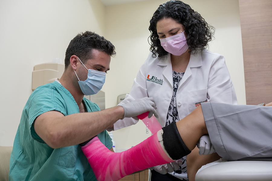 Orthopedic staff assessing a patient's leg