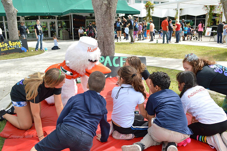 Students interacting with Sebastian the Ibis