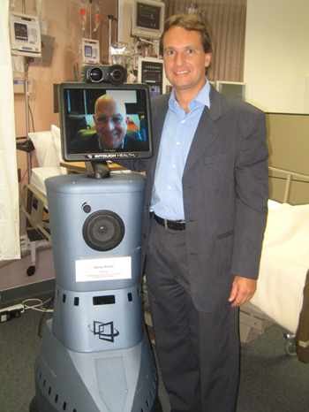 Dr. Martos posing with a telemedicine cart