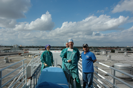 Surgeons pose for an image on the top of a roof