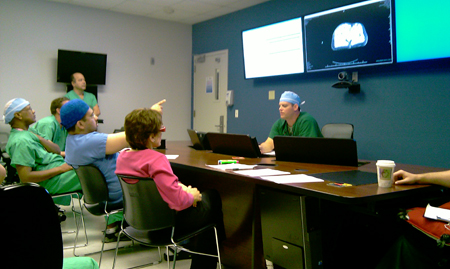 Group of surgeons discuss a patient's file