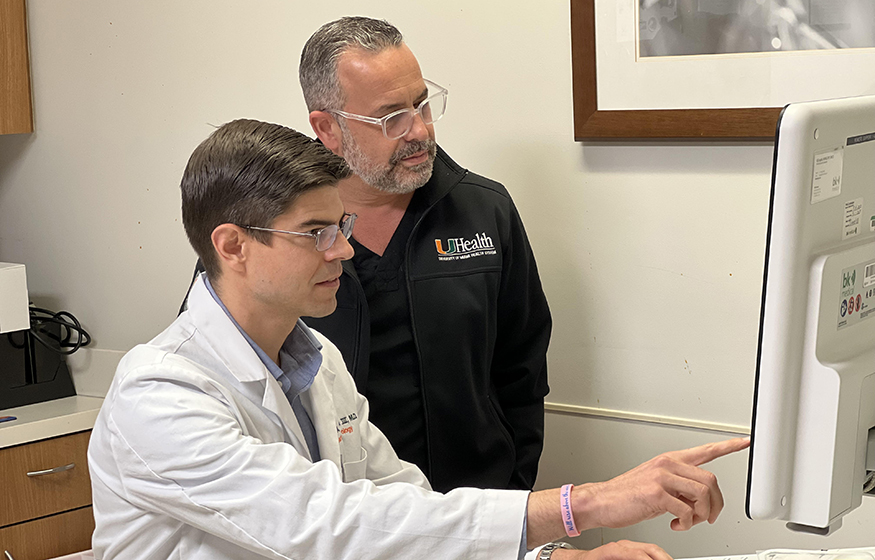 Two physicians in front of a computer workstation
