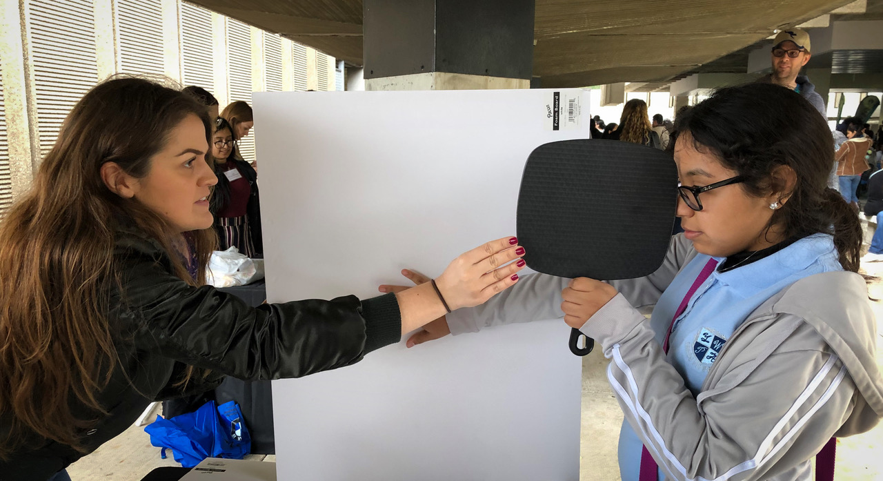 One student demonstrating to another her presentation