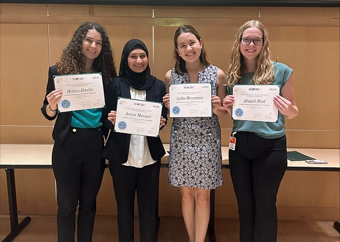 Four women pose with their certificates