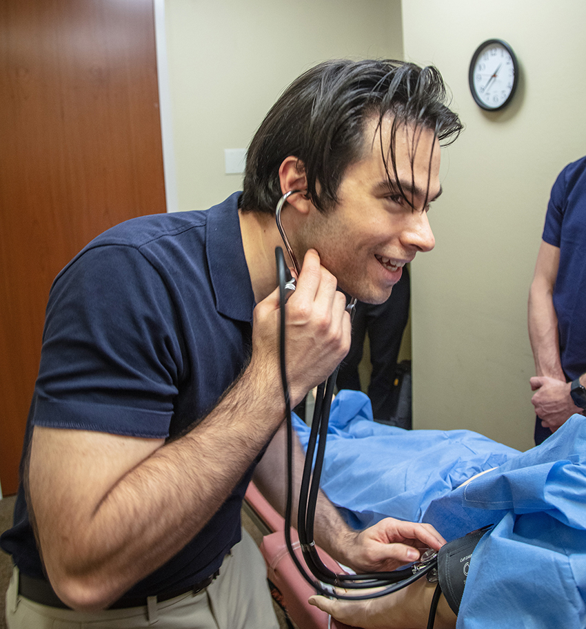 Medical student using a stethoscope