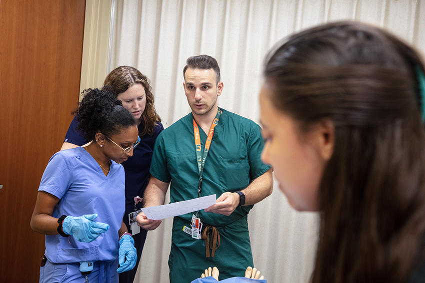Medical students engaging in a hands-on simuation