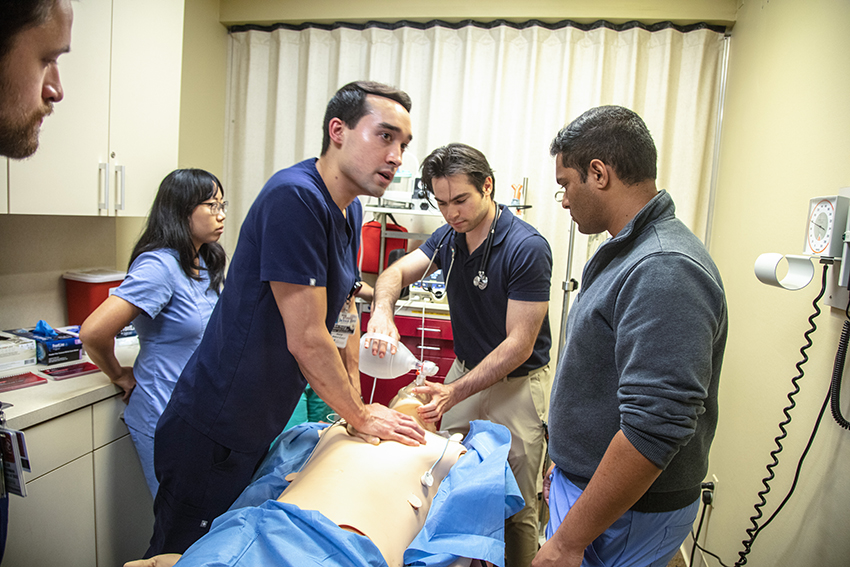 Medical students performing CPR on a dummy