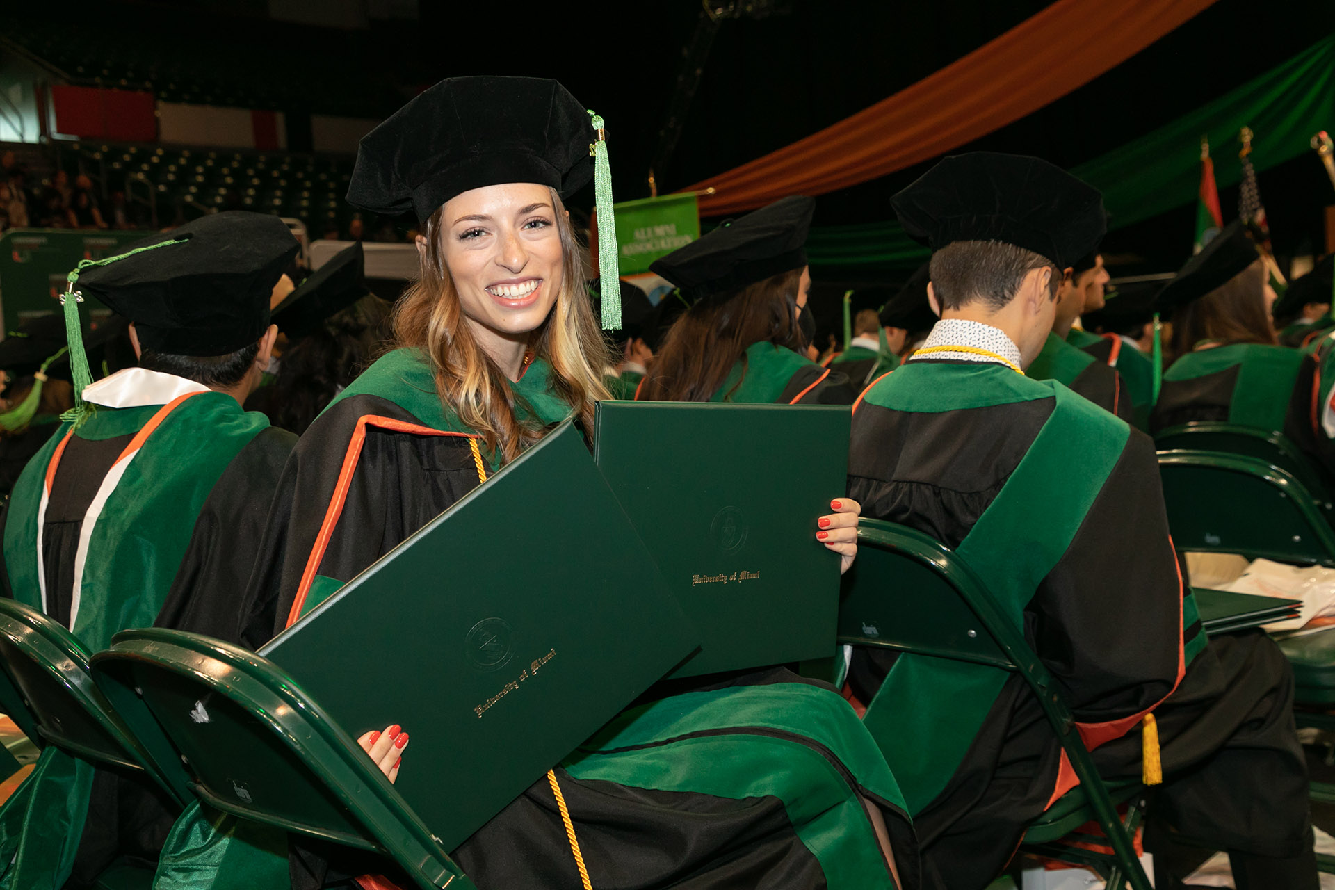 Newly graduated medical doctor holds up dual degrees