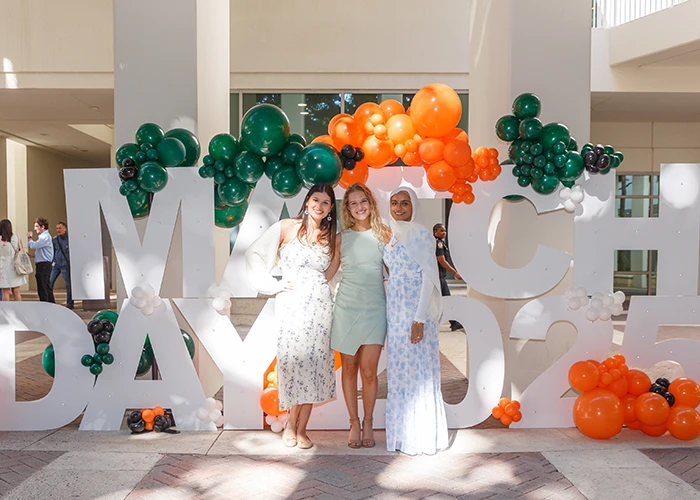 three women pose for a photo at match day 2025