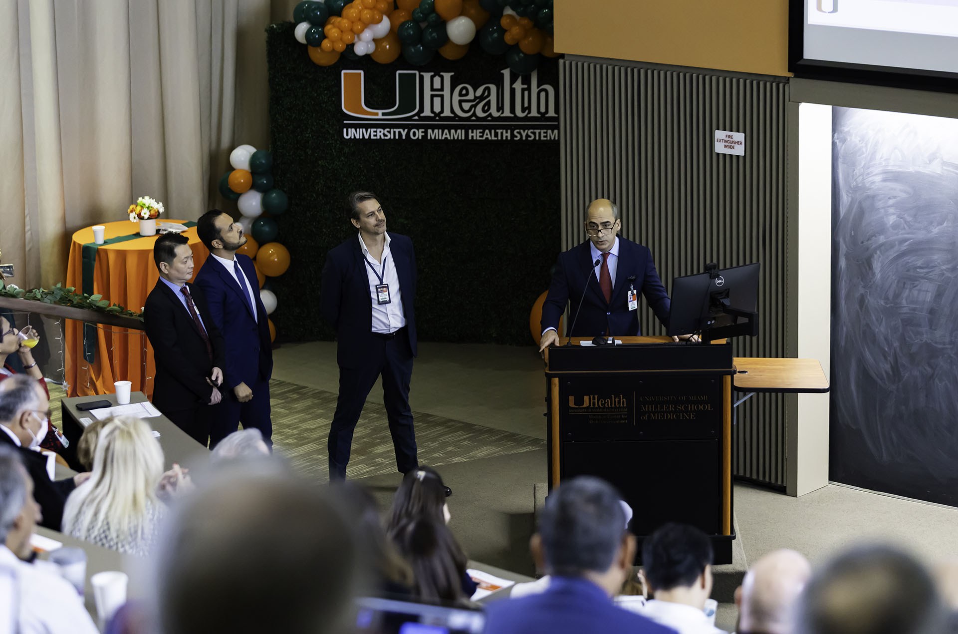 medical education admins speaking on stage