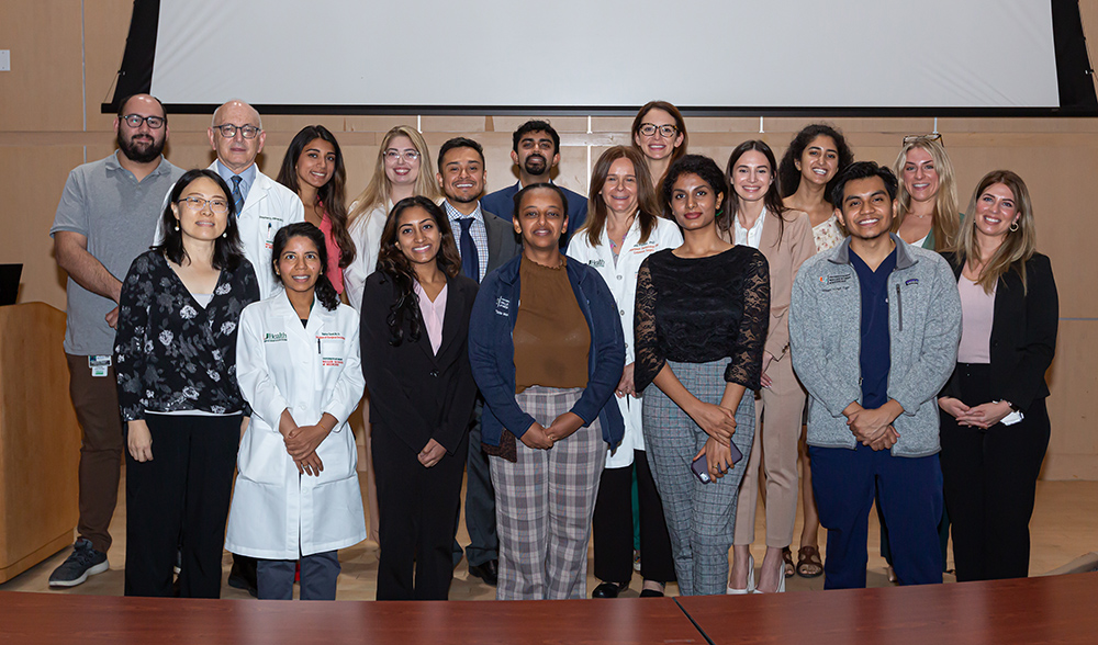 Large group of DREAM students and faculty posing together in a lecture hall