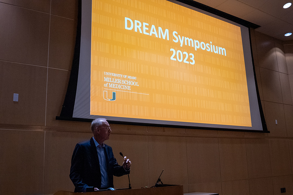 Man speaking at a podium during the DREAM Symposium 2023 at University of Miami