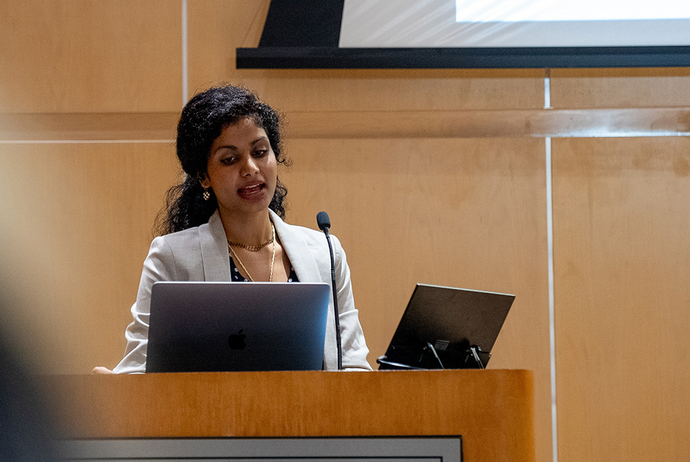 Woman presenting at a podium during the DREAM Symposium at University of Miami