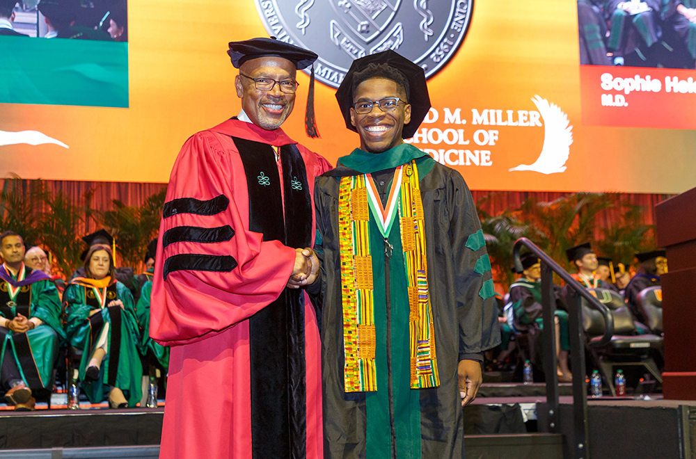 Dean Ford and colleague in graduation gowns