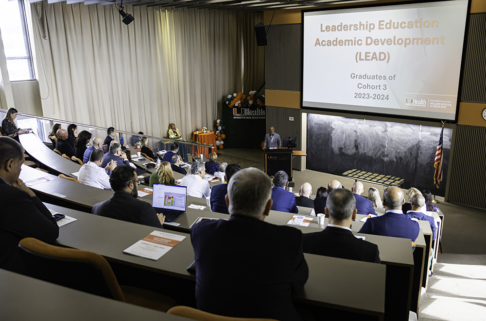 Speaker at podium addressing audience during LEAD graduation event