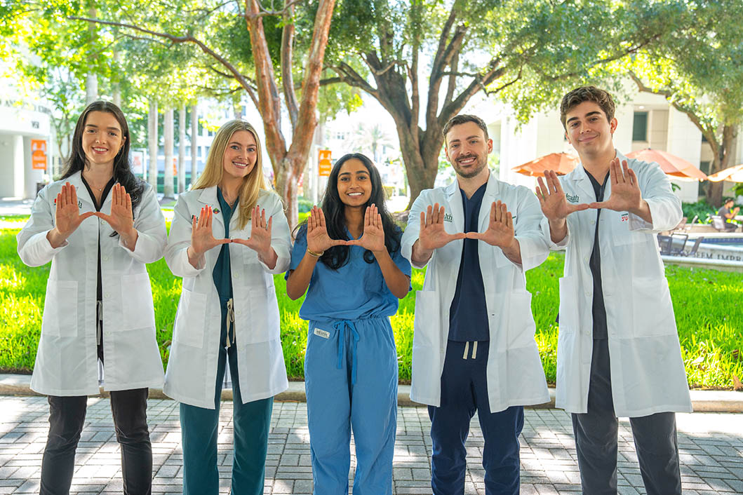 Group poses for a photo on campus