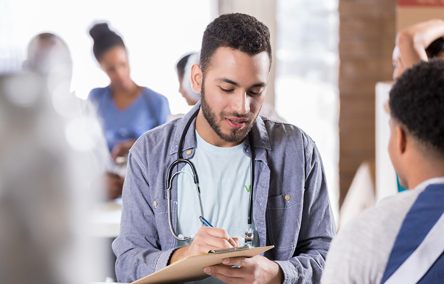 Young male doctor volunteers in free clinic