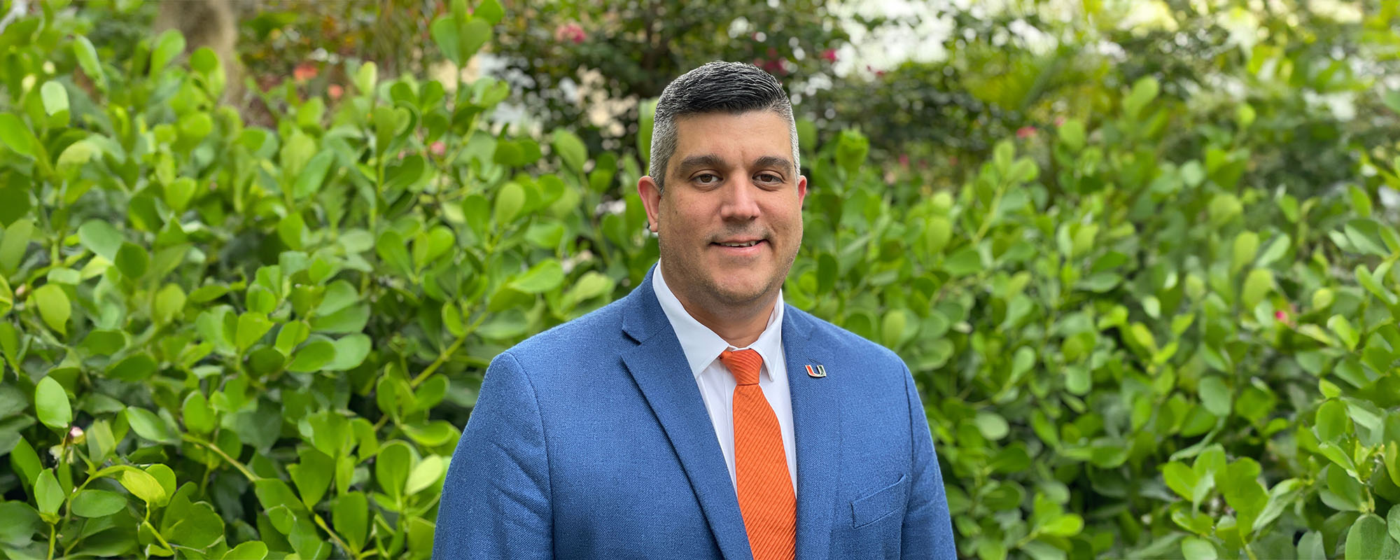 Dr. Alberto Caban-Martinez in suit and tie