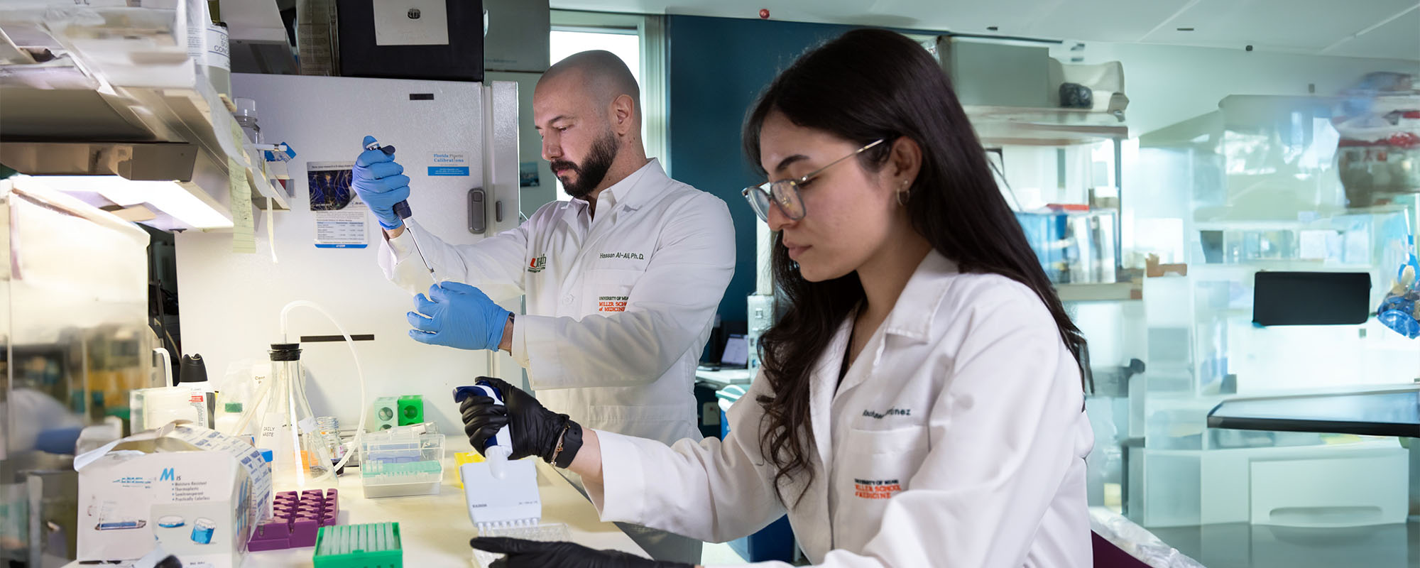 Dr. Hassan Ali, working in the lab with a colleague