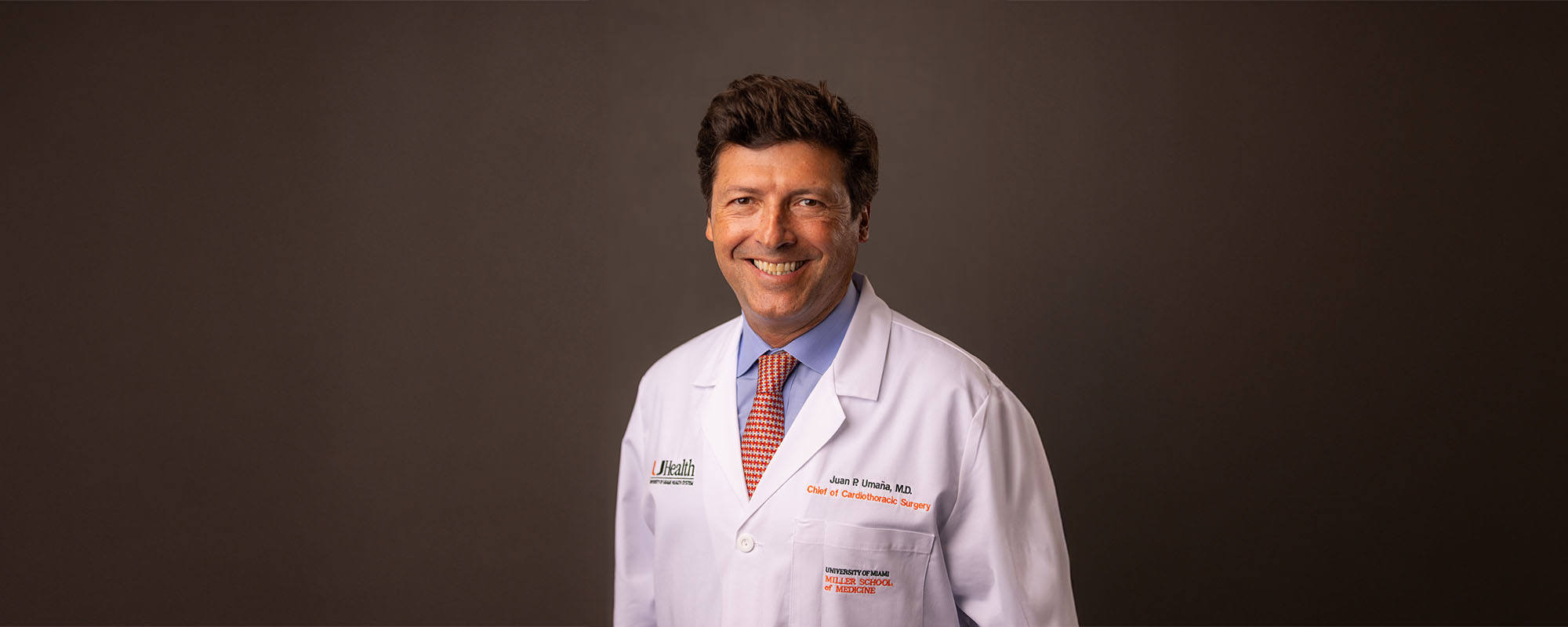Dr. Juan Pablo Umaña in white clinic coat