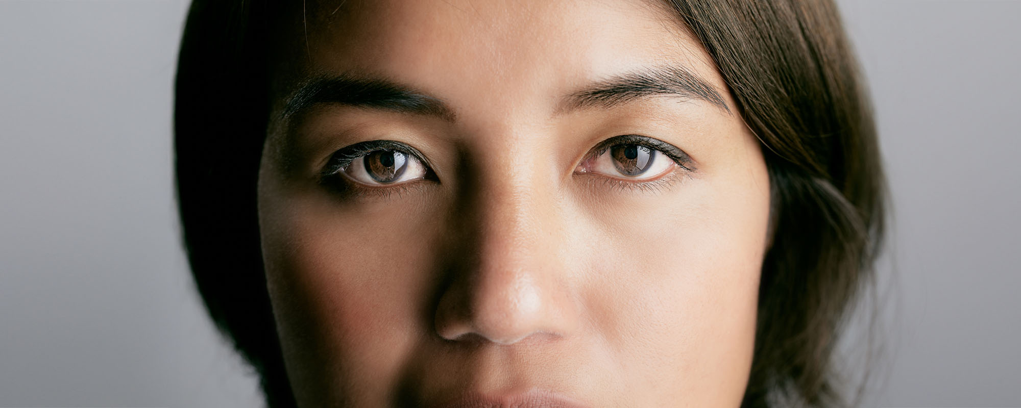 A young woman's face, with a closeup focus on her eys
