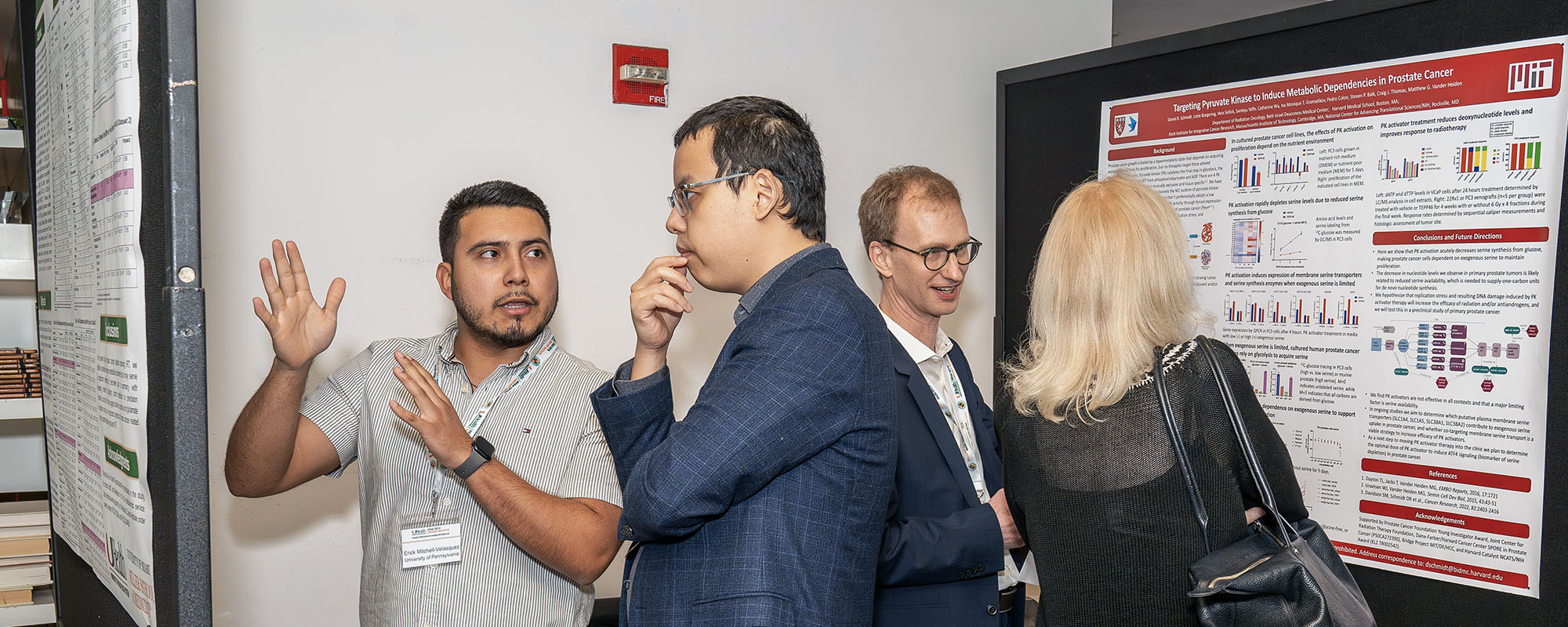 Four scientists at a poster presentation at the Miami Human Metabolism Symposium