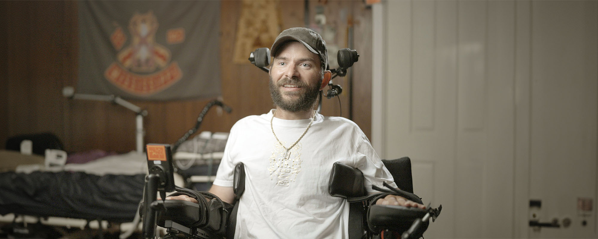 Neuralink implant recipient KJ, seated and smiling