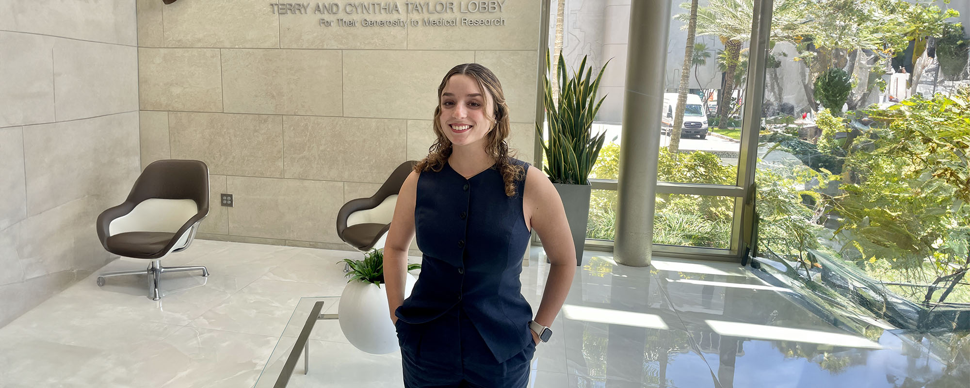Medical student Rebecca Kaiser standing in the lobby of a medical library