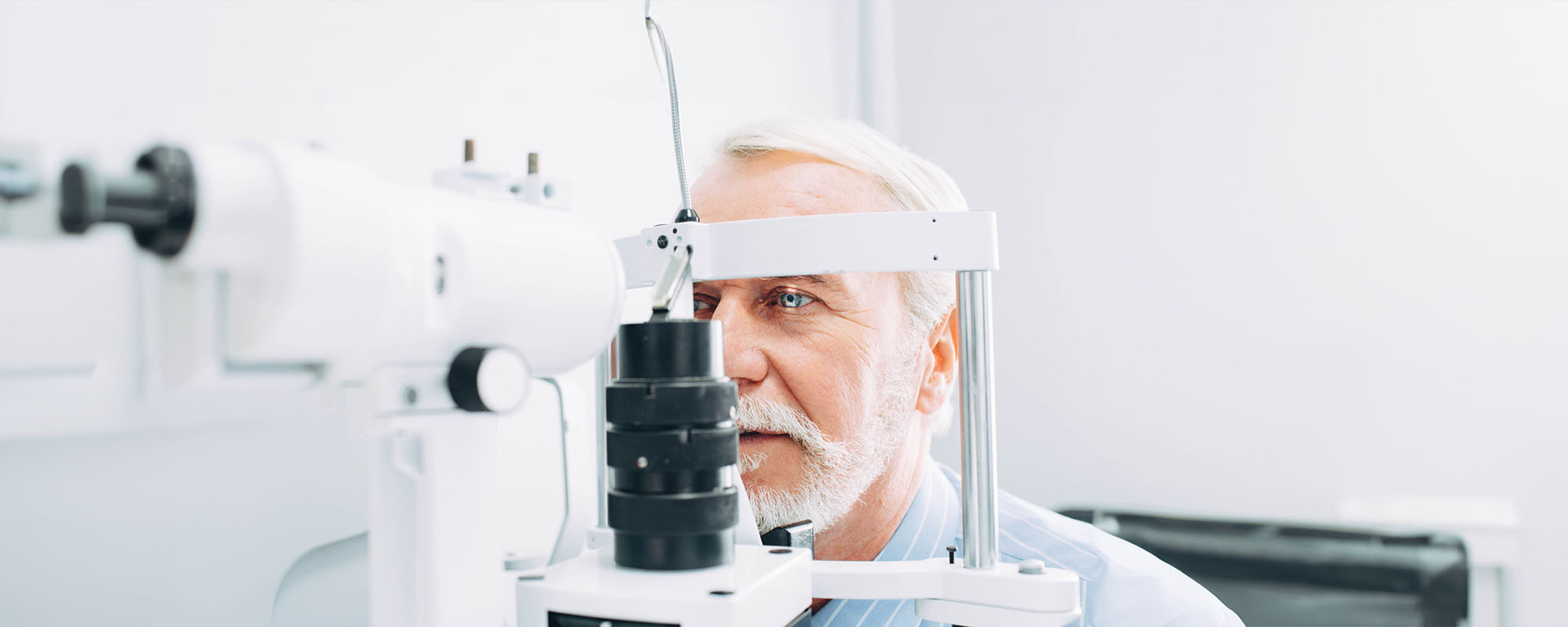 A silver-haired man taking a vision test